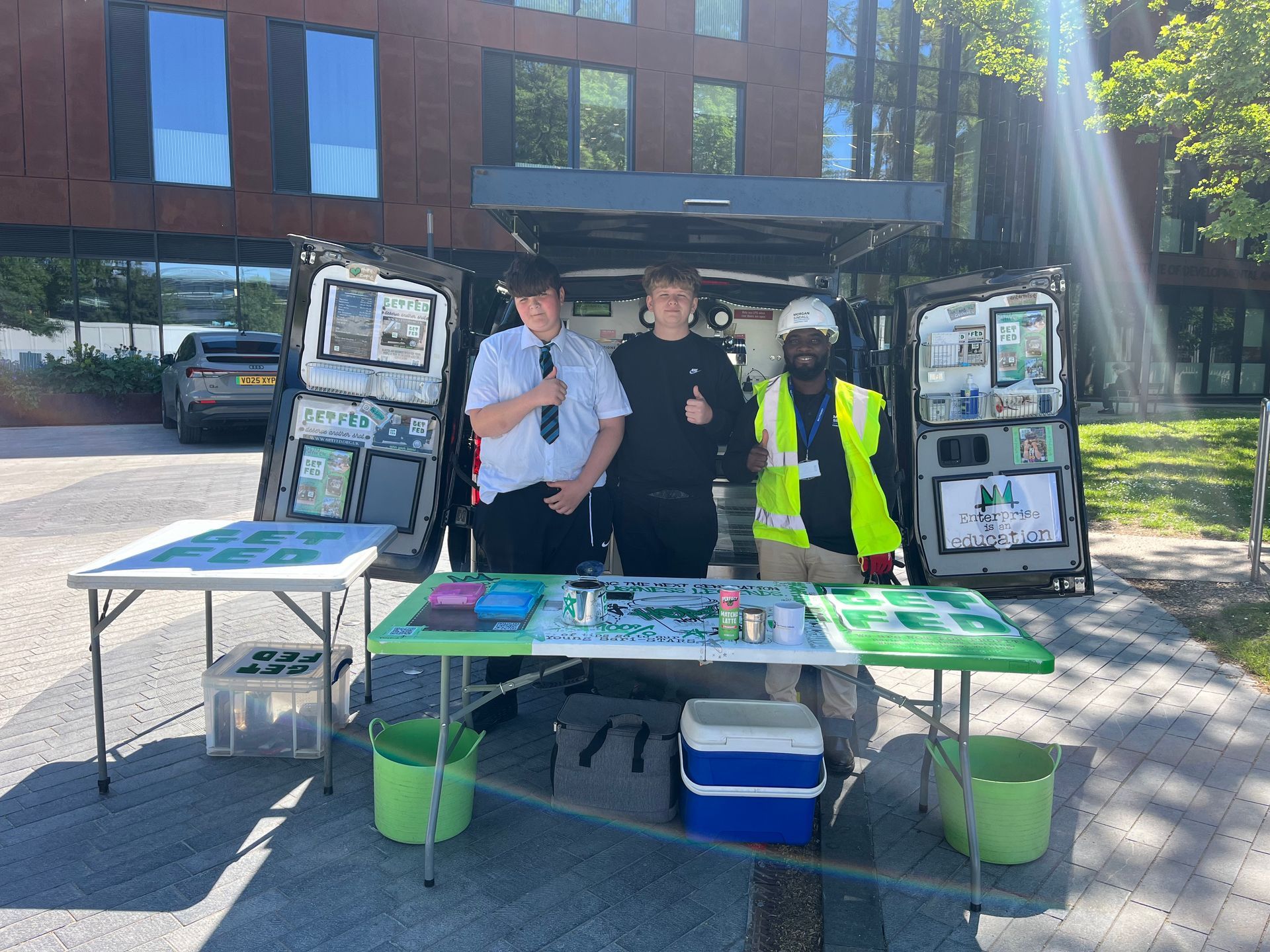 Two students serving drinks