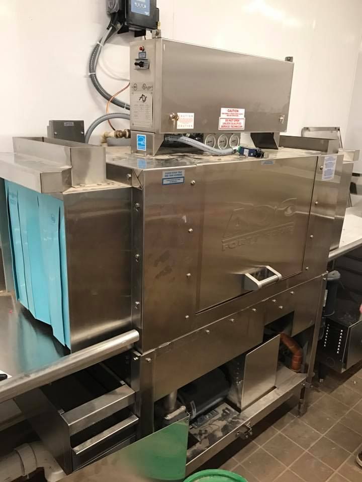 Commercial stainless steel dishwasher in a kitchen setting.