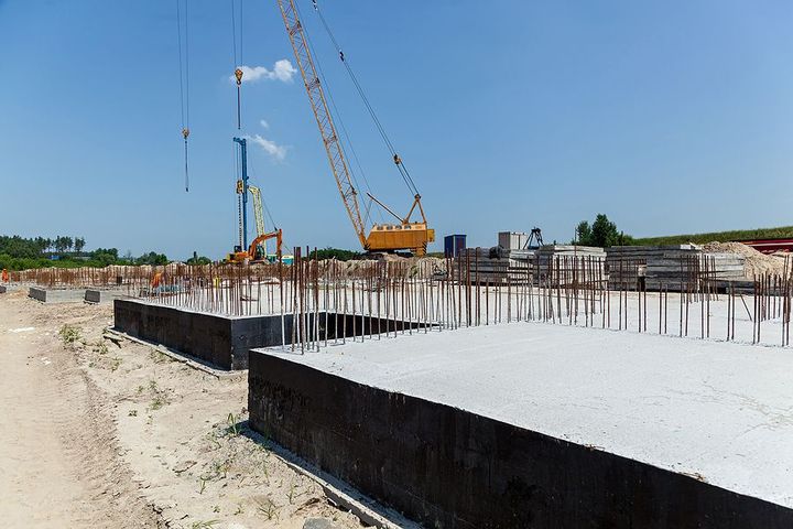 a construction site with a crane in the background