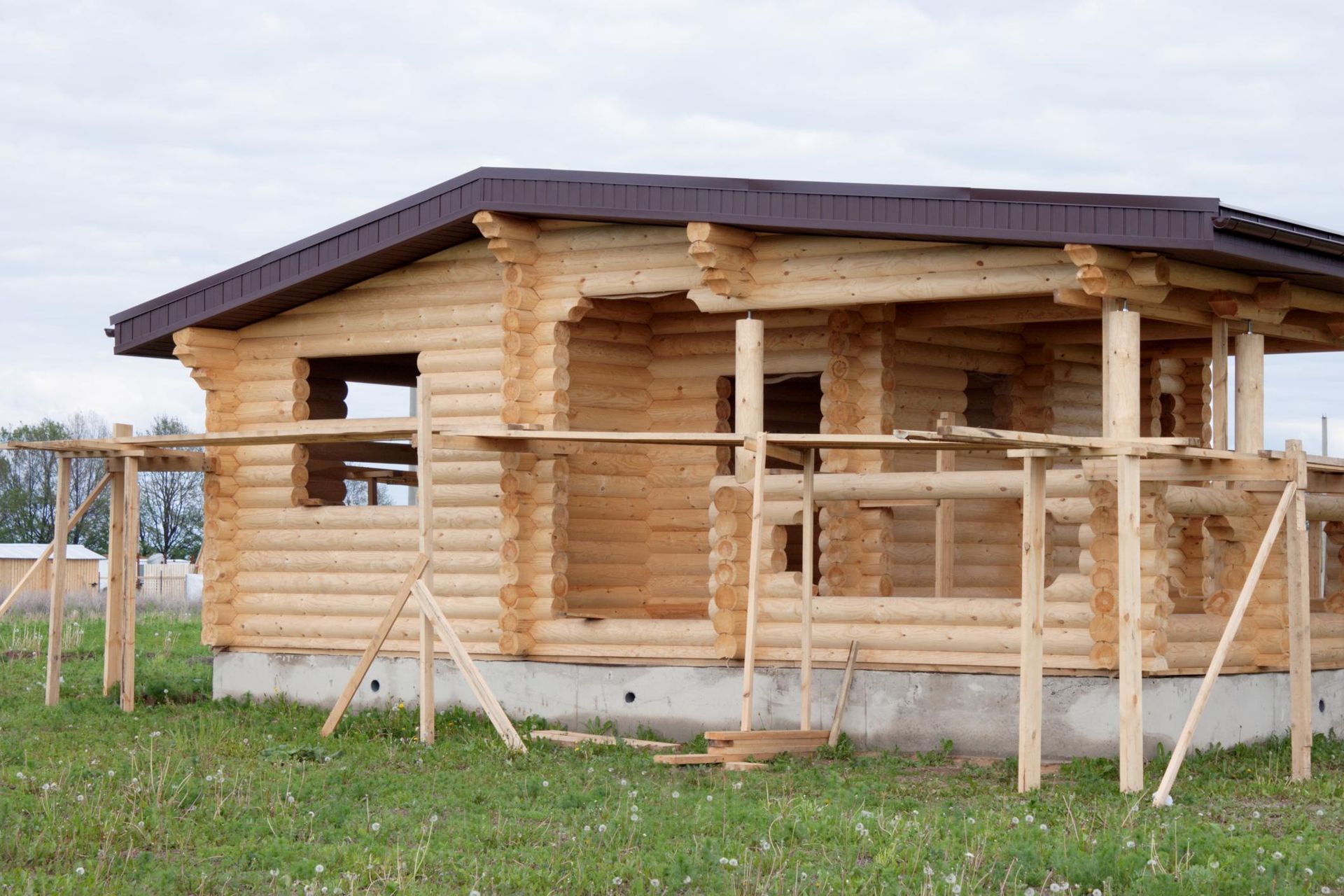 a log cabin being built in a field