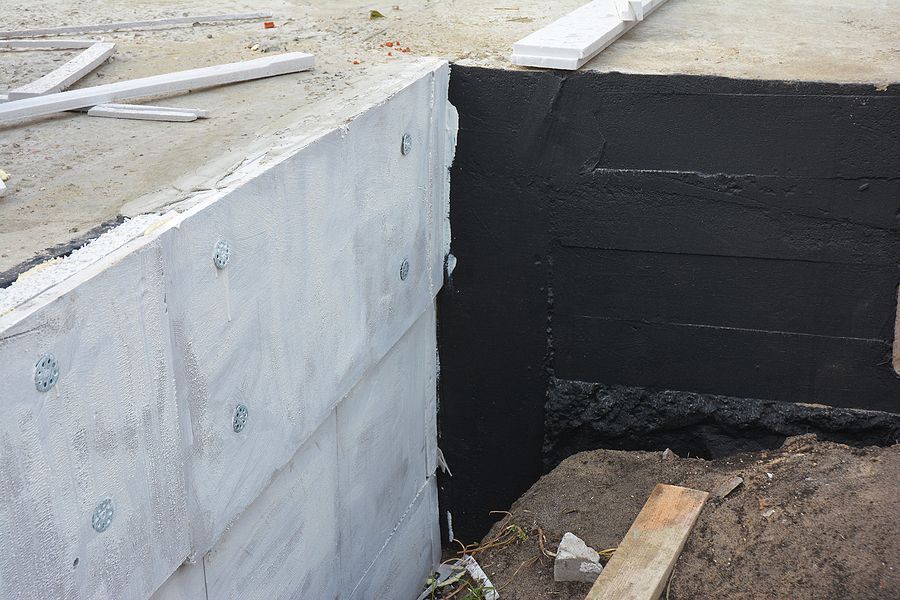 a construction site with a cement wall and a cement block