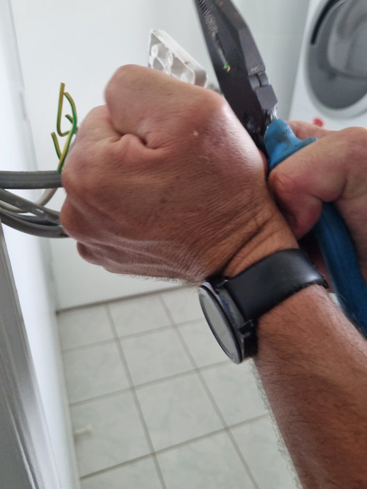 Electrician Holding Pliers — Electricians In Bundaberg, QLD