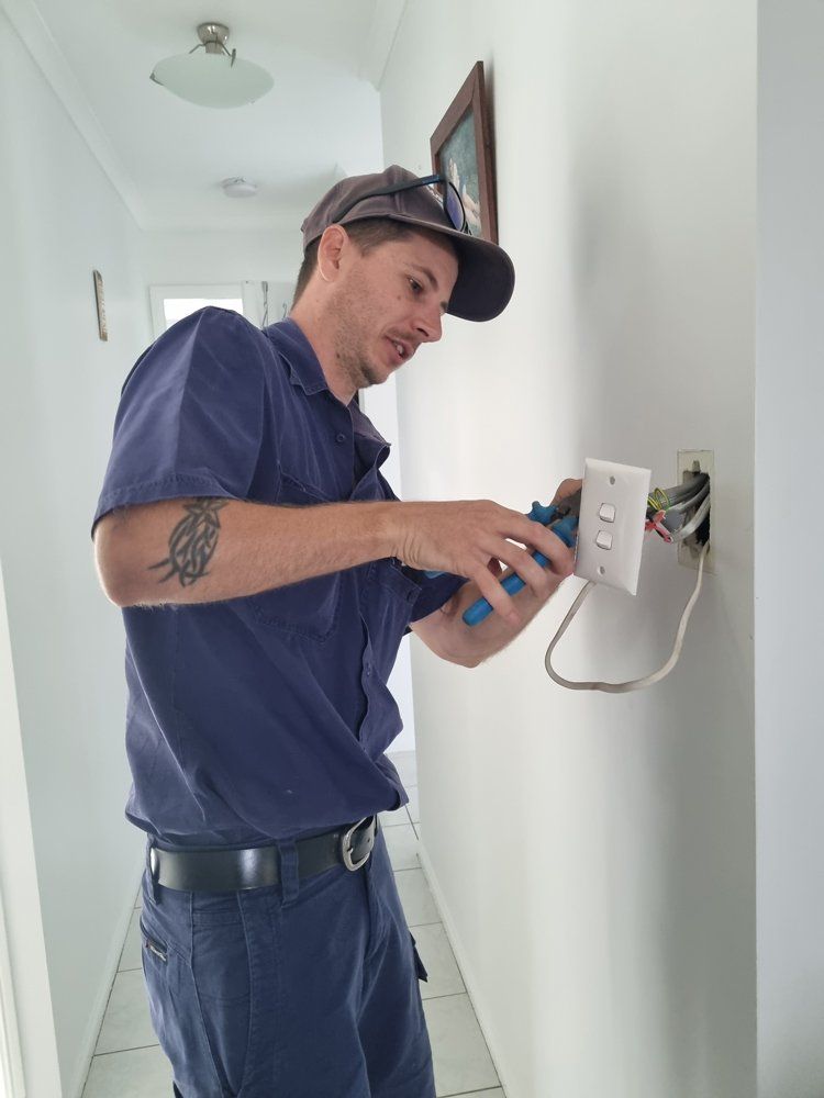 Electrician Using Pliers On The Light Switch — Electricians In Bundaberg, QLD