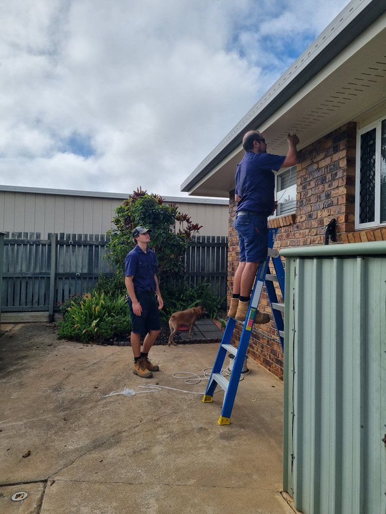 Two Electricians Repairing Home Wiring — Electricians In Bundaberg, QLD