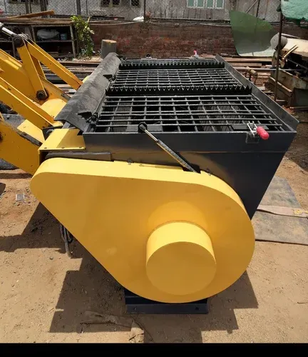 Yellow and gray industrial concrete mixer machine, outdoors, sunny.