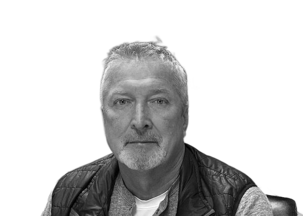 Man smiling, wearing a suit and tie, against a white background.