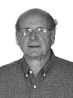 Man wearing glasses and a button-down shirt, looking directly at the viewer.