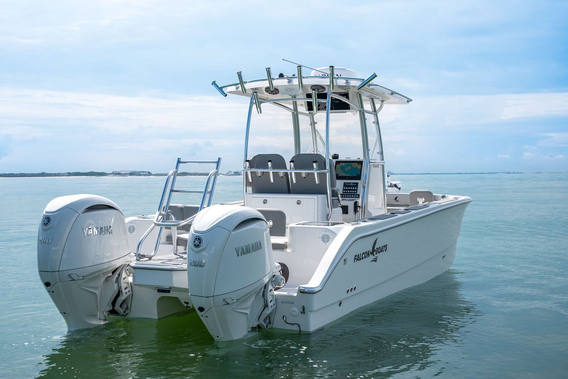 A blue and white motorboat on the water with a cityscape in the background under a bright, sunny sky.