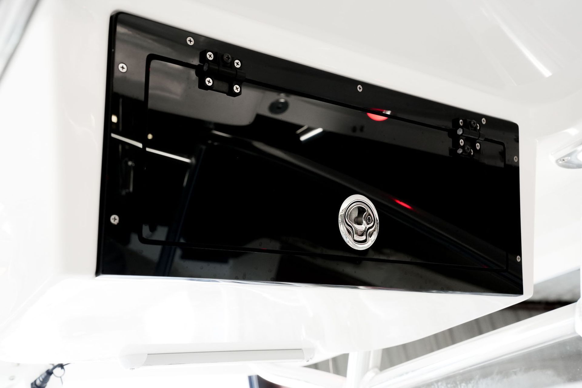 Boat seat with gray and white cushions and blue base, featuring a black bird logo.