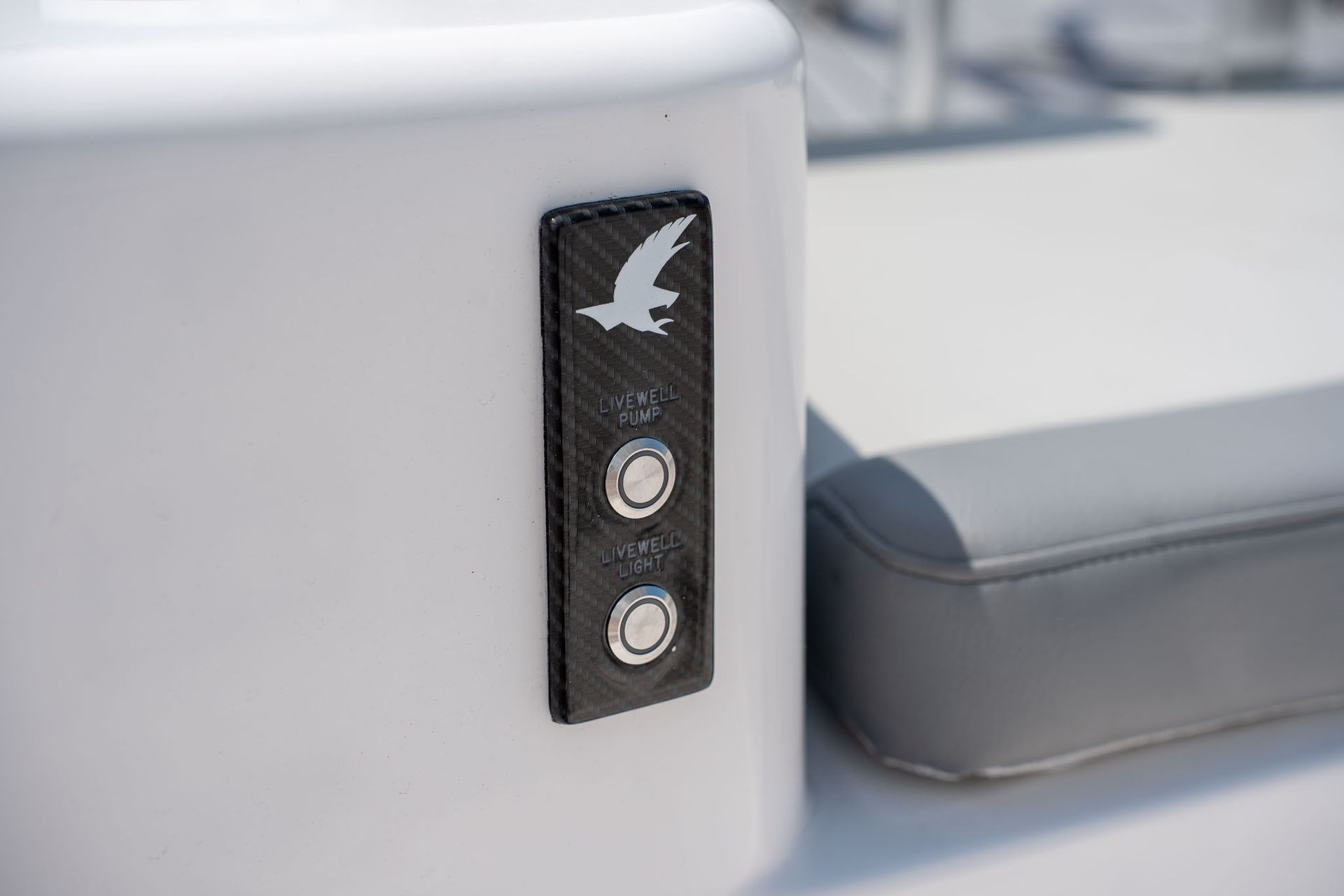 A silver boat ladder attached to the back of a blue boat, with a red reflector bar.