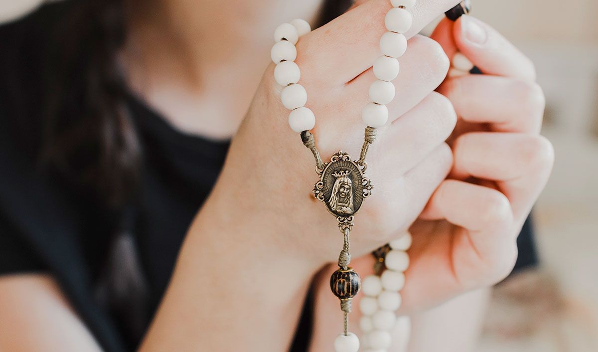 woman holding prayer beads