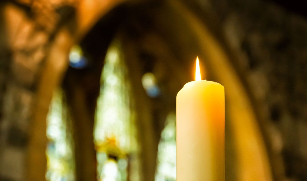 Memorial candle burning in a Catholic church lit  in prayer for a loved one