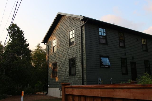 A large house with a wooden fence in front of it