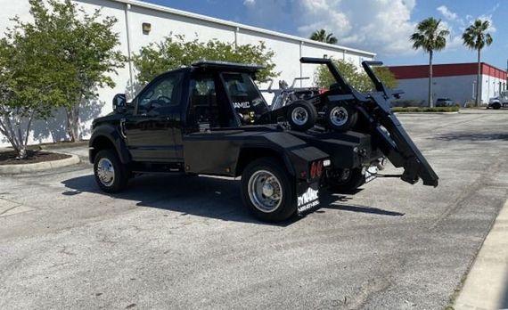 The hood of a car is open and the engine is visible.