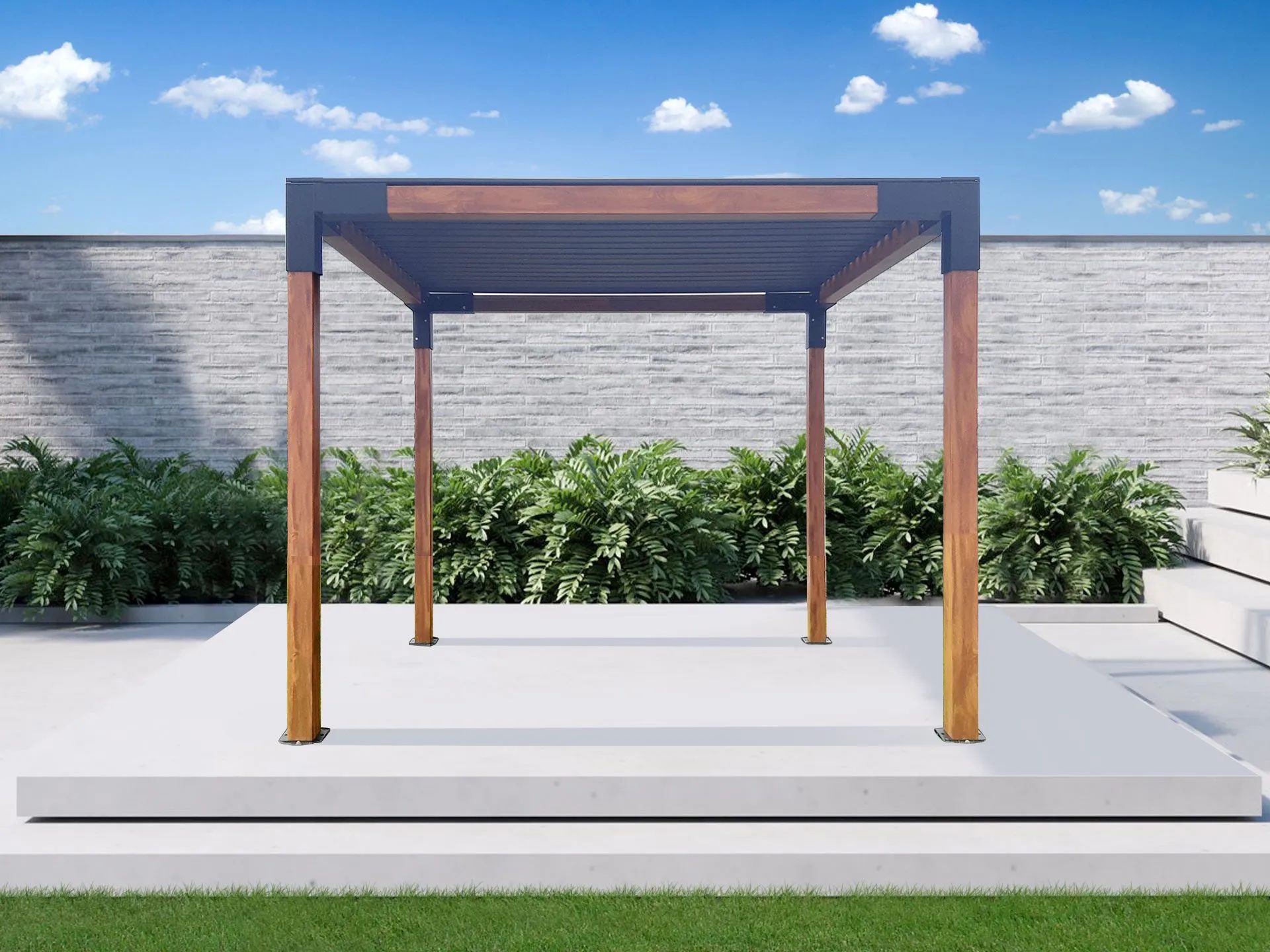 A wooden pergola is sitting on top of a concrete patio next to a brick wall.