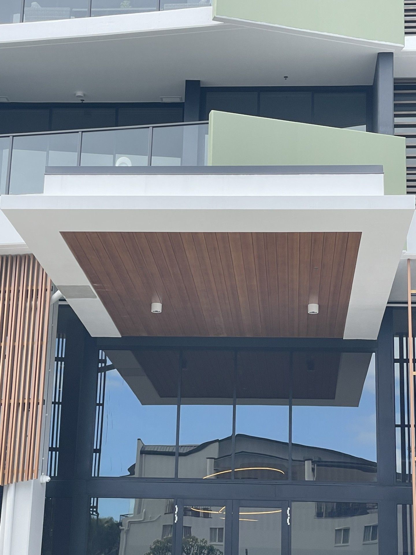 A building with a balcony and a wooden ceiling