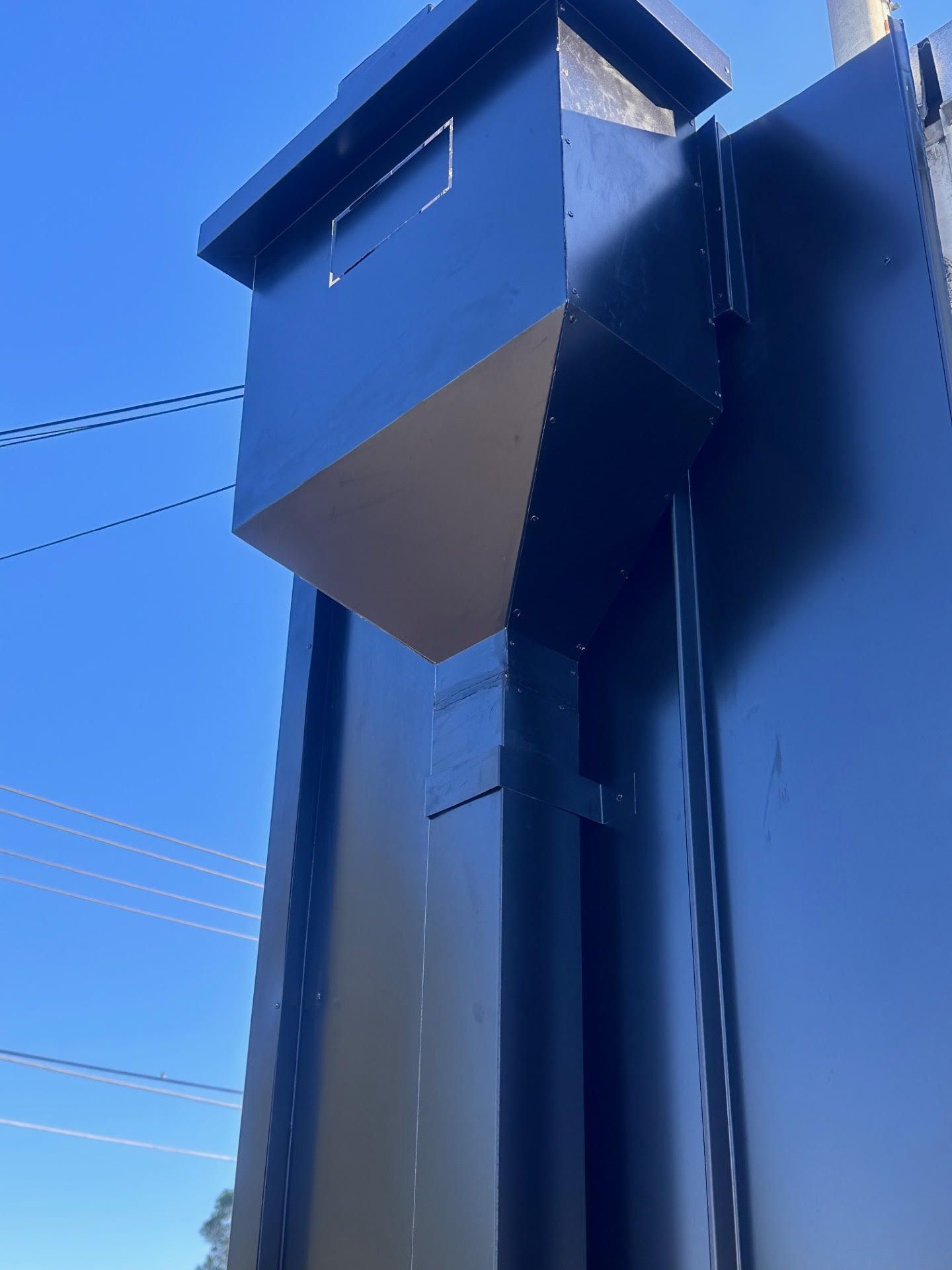 A black building with a blue sky in the background