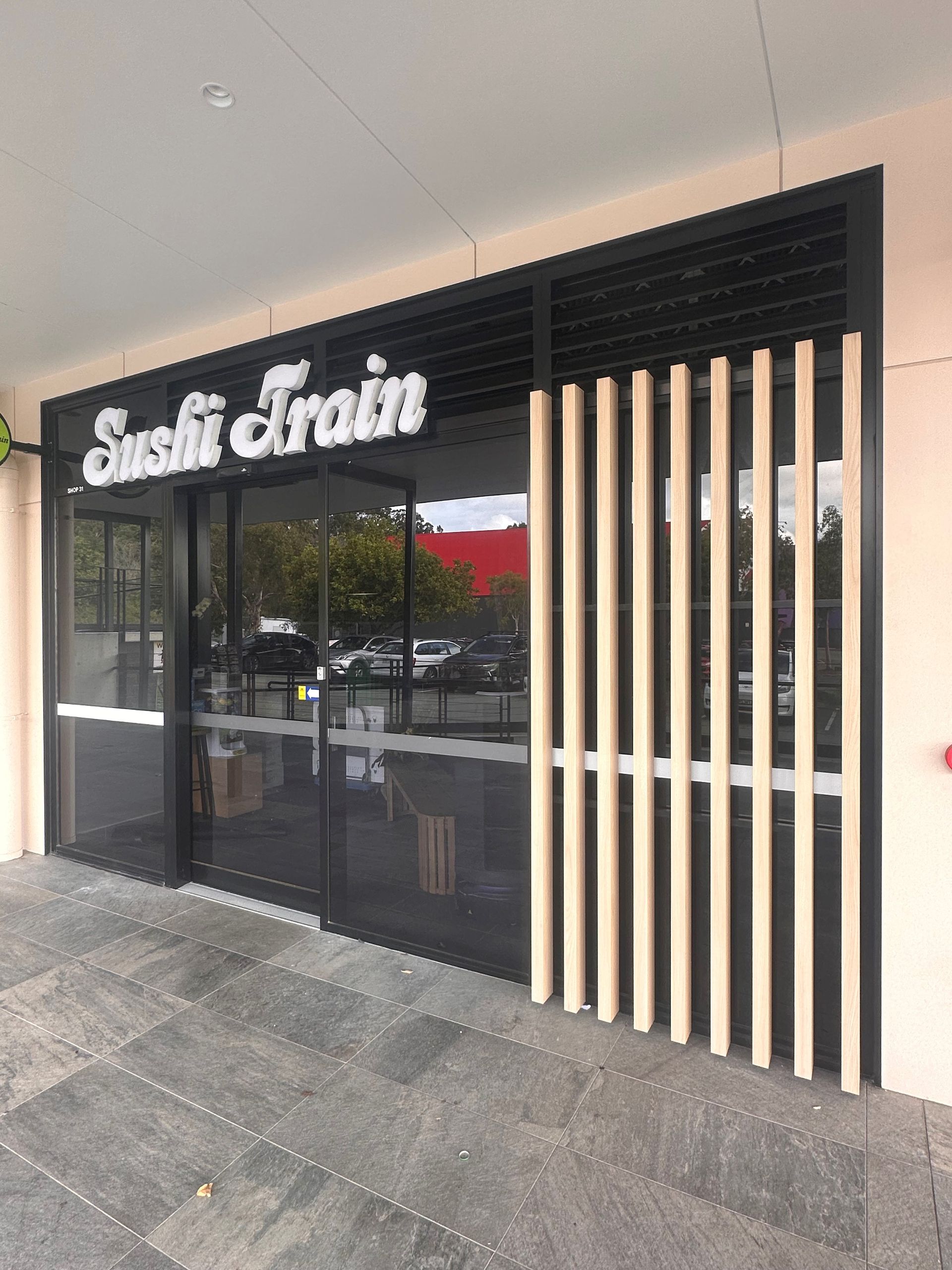 A restaurant with a sign that says sushi train on it