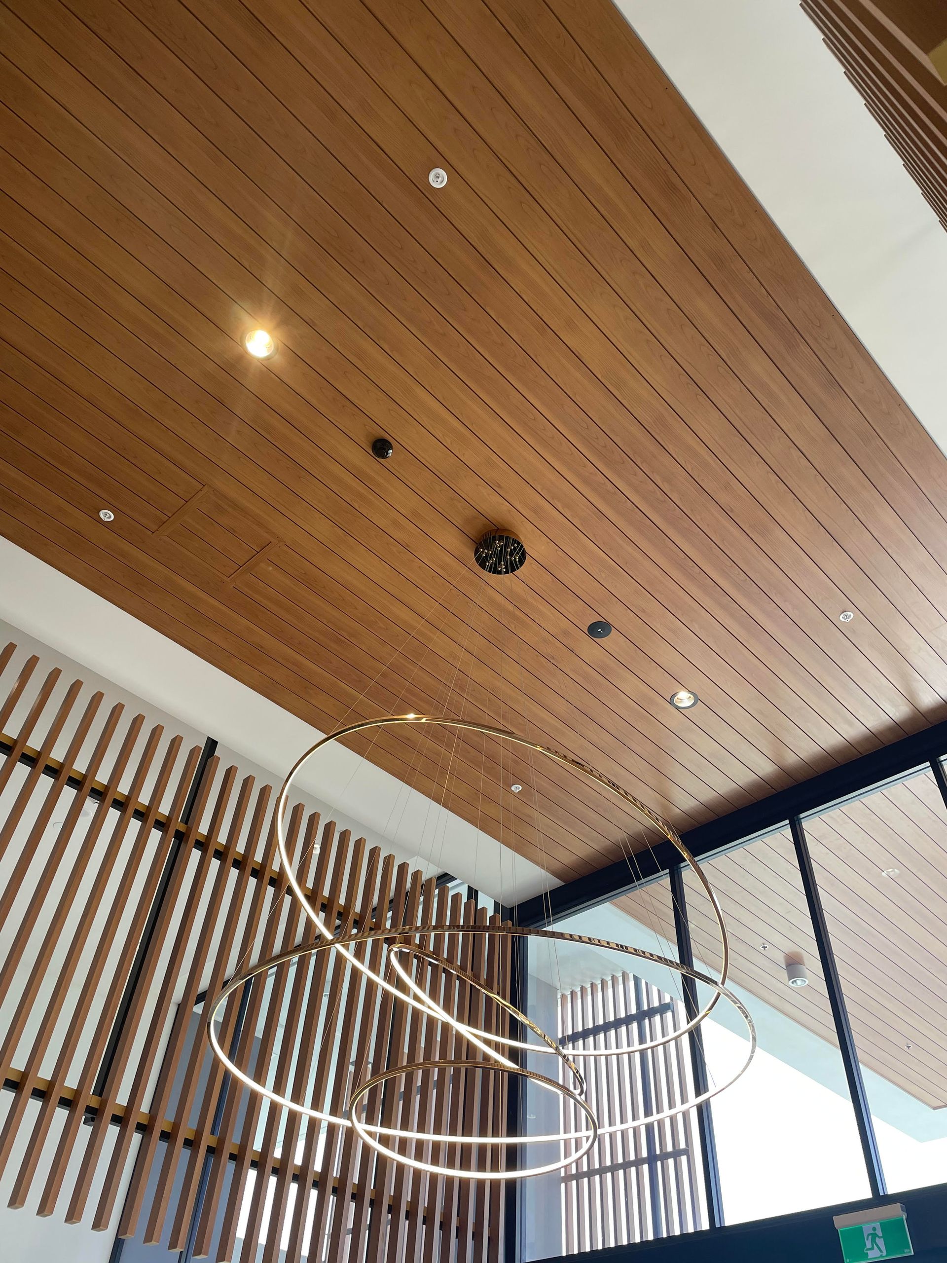 A room with a wooden ceiling and a chandelier hanging from it