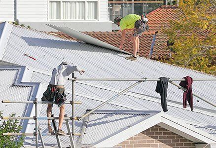 Two Men Working on a Roof — Roof Repairs & Installation in Coffs Harbour, NSW