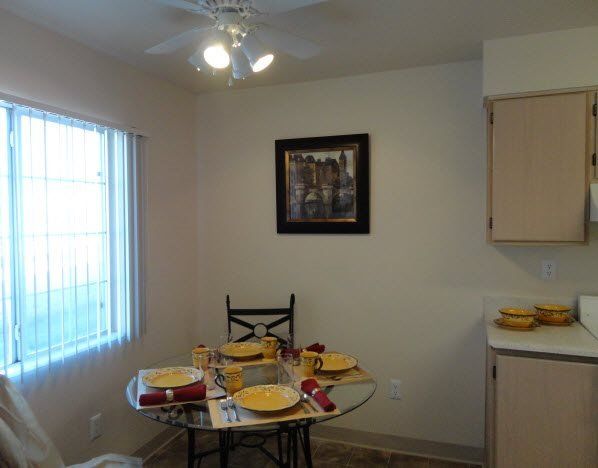 Interior view of small dining table with large window adjacent