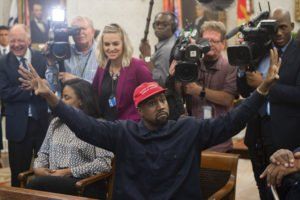 Kanye West raises arms