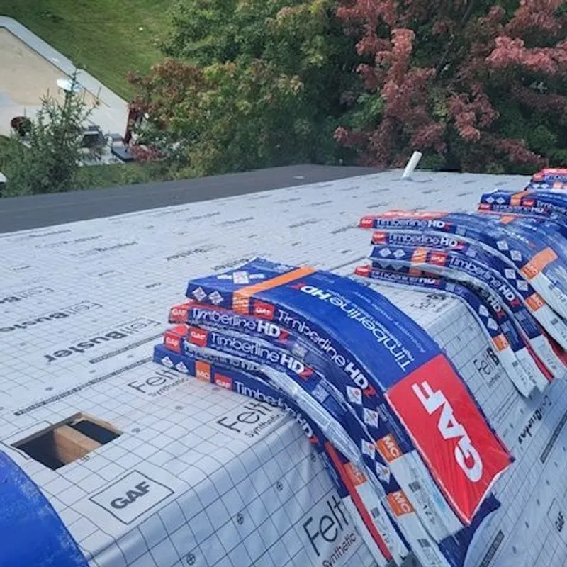 Roof being worked on with GAF Timberline HDX shingles and underlayment visible.