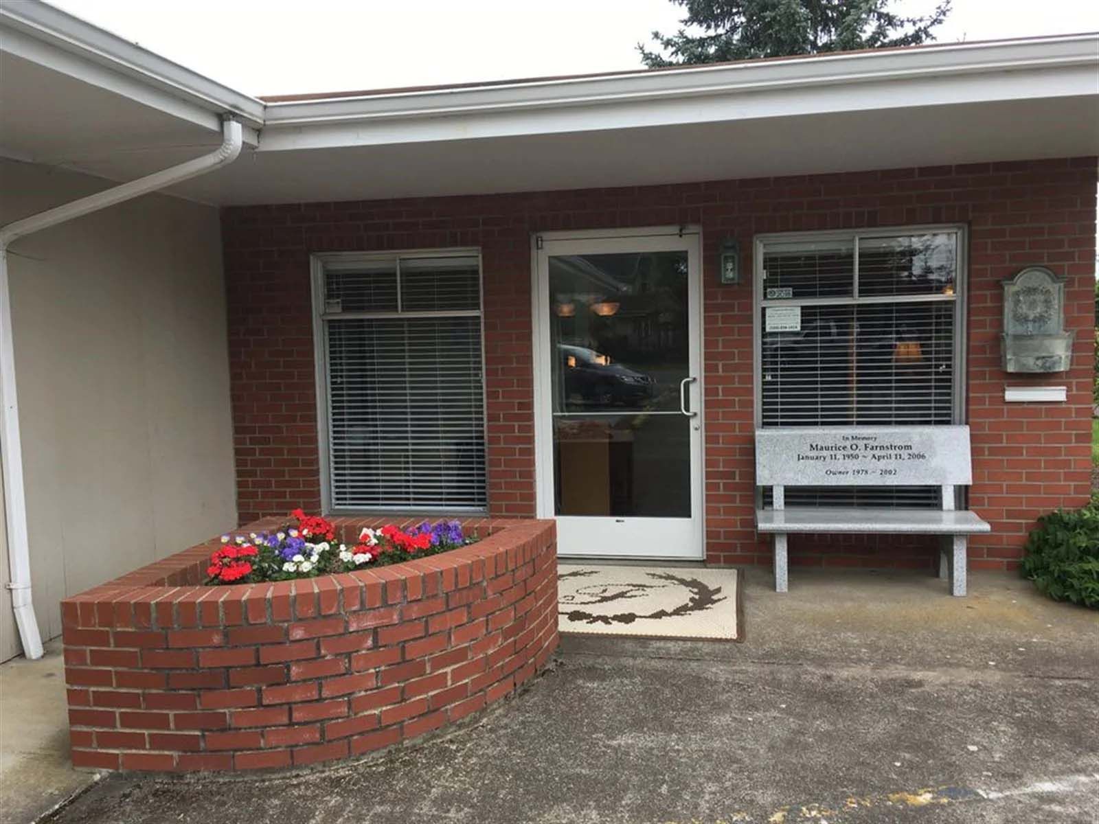A brick building with a bench in front of it