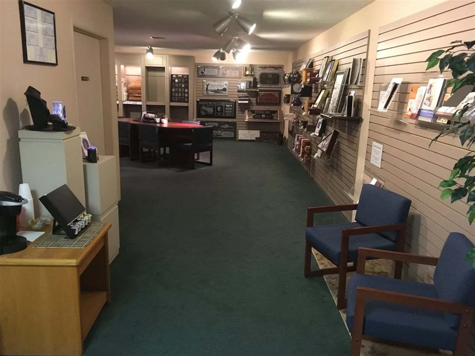 A long hallway with chairs and a desk