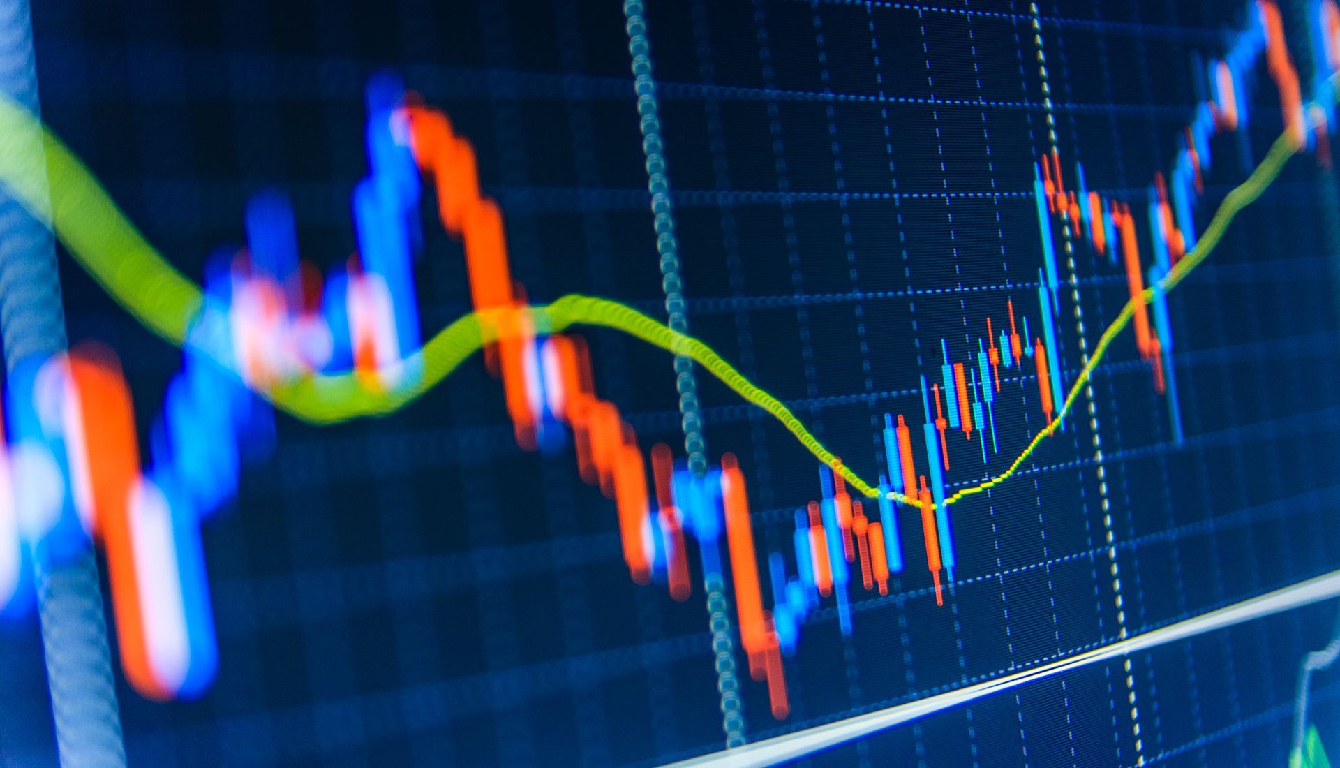 Stock market graph displaying red and blue bars with a green trend line on a blue screen.