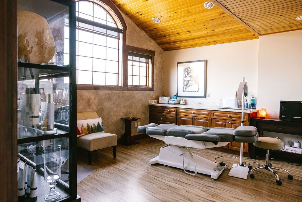 Red anthurium flowers with yellow spadices, green leaves, against a dark background.