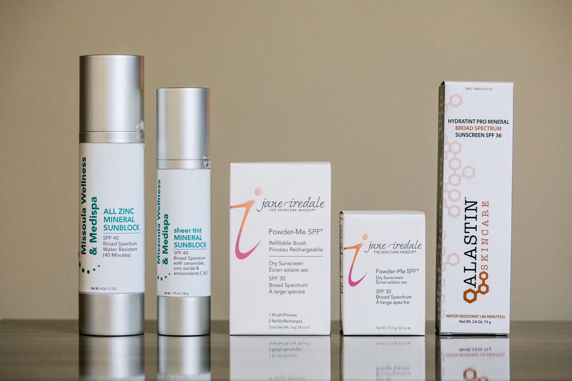 Several bottles and boxes of galaskin products are lined up on a table
