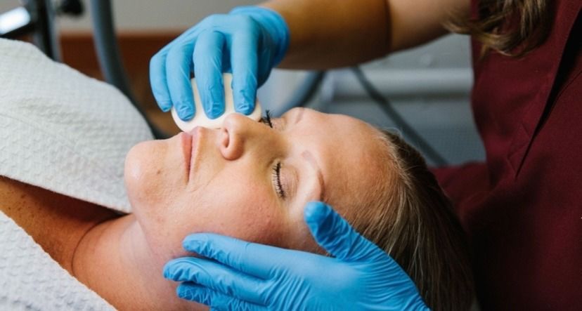A woman is getting a facial treatment at a spa.