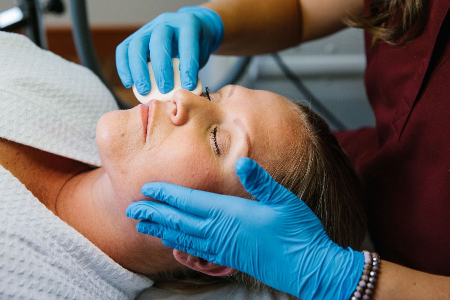 A woman is getting a facial treatment at a spa.