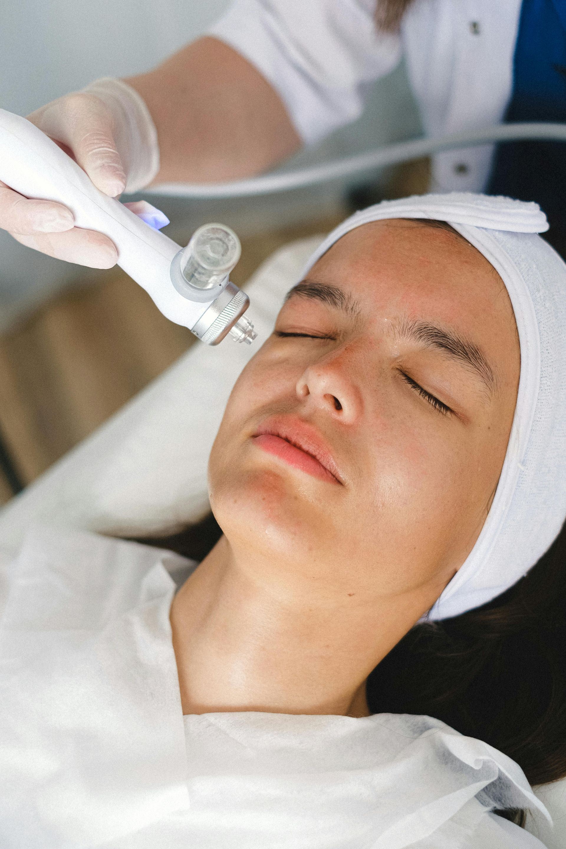 A woman is getting a facial treatment at a beauty salon.