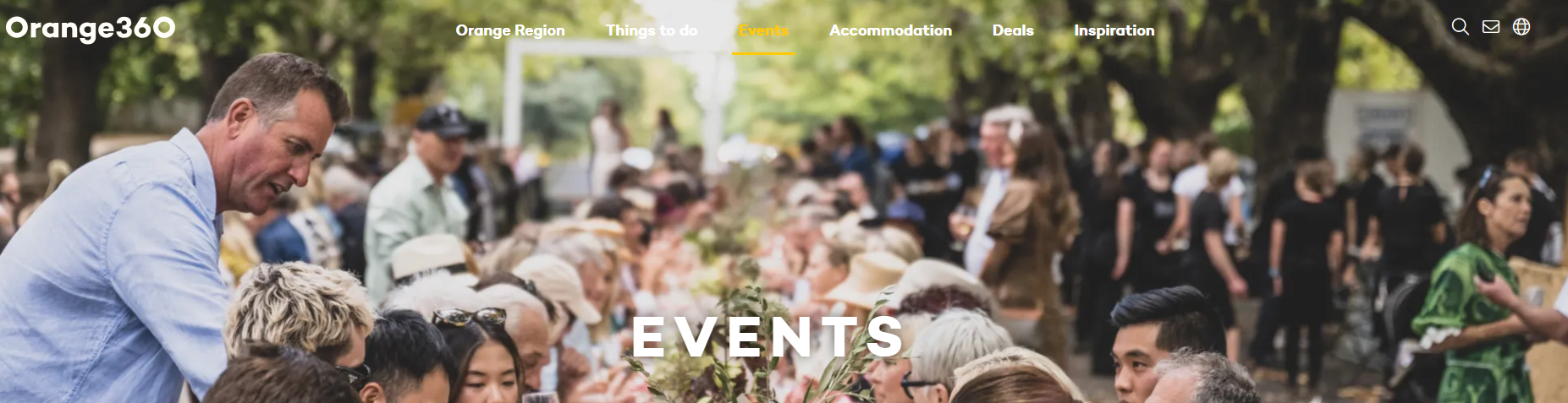 Crowded outdoor event in a park with people mingling under trees, “EVENTS” text overlaid on the scene