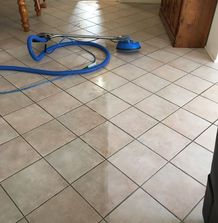 Floor Tiles Being Cleaned With a Blue Machine — Clean Coast Carpet Cleaning in Port Stephens, NSW