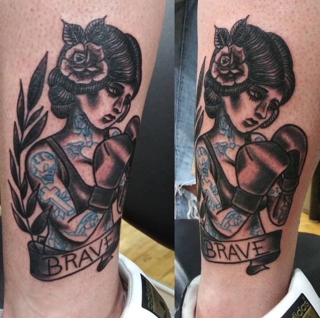 Tattoo artist in black gloves, tattooing a detailed design on a person's arm, studio setting.