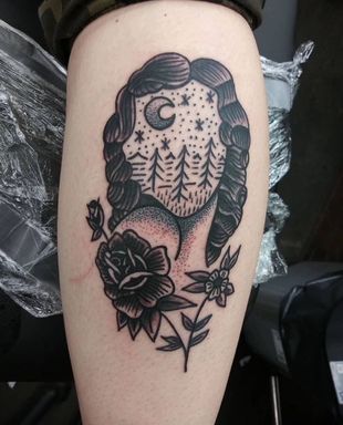 Man getting a tattoo on his shoulder by a tattoo artist in a studio, both focused.