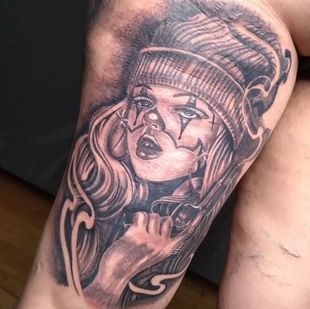 Man smiling, getting a wrist tattoo. A gloved hand holds the wrist.