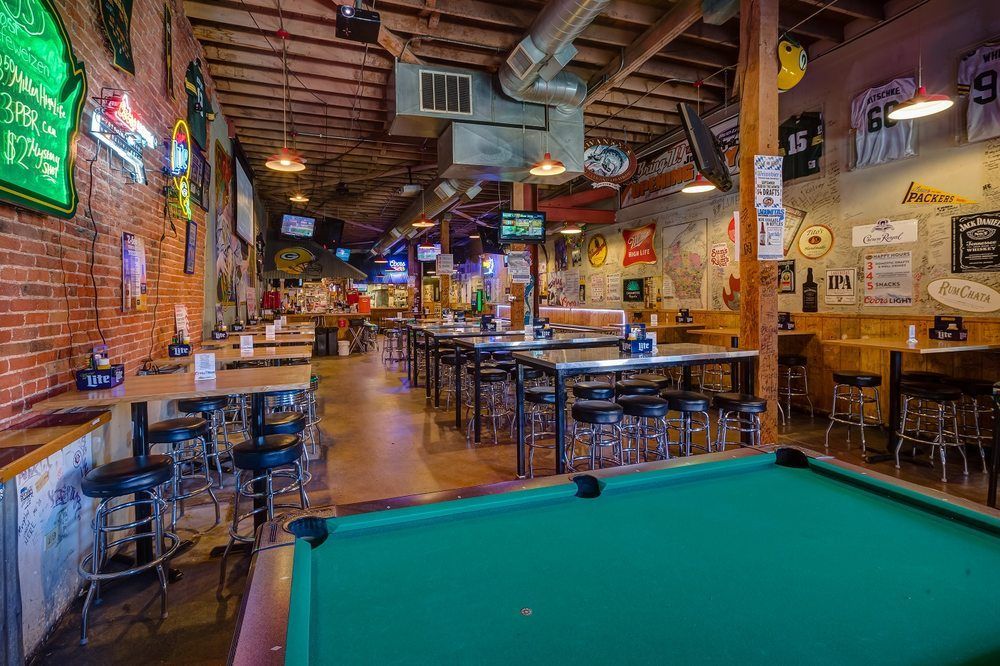 There is a pool table in the middle of the room at swankys sports bar in denver colorado