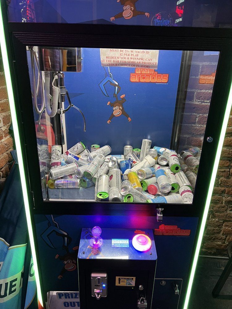 A machine with a monkey on it is filled with cans at swankys sports bar near coors field in denver colorado