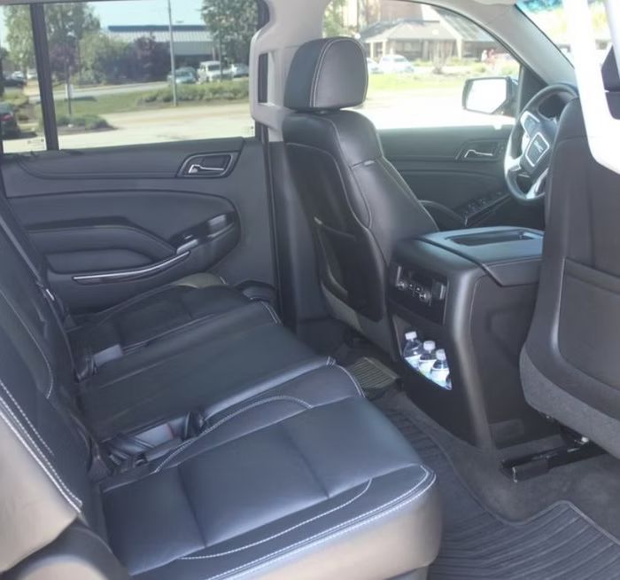 The back seat of a car with a bottle holder