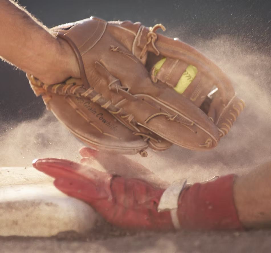 A baseball player with a glove that says wilson on it