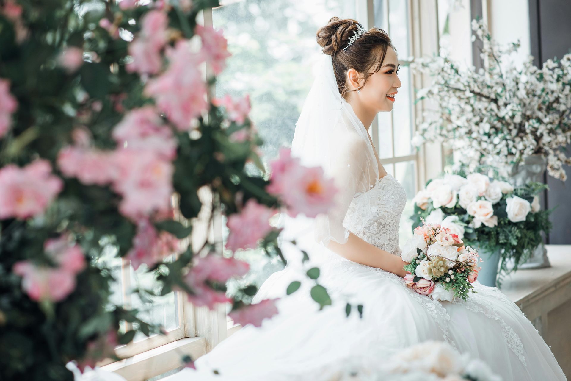 Bride on her wedding day surrounded by flowers
