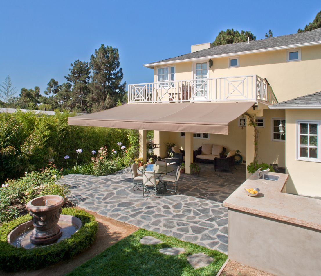 A large house with a large awning over the patio