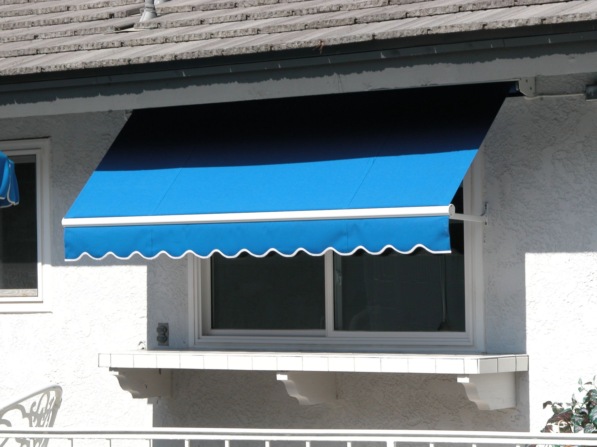 A window with a blue awning over it