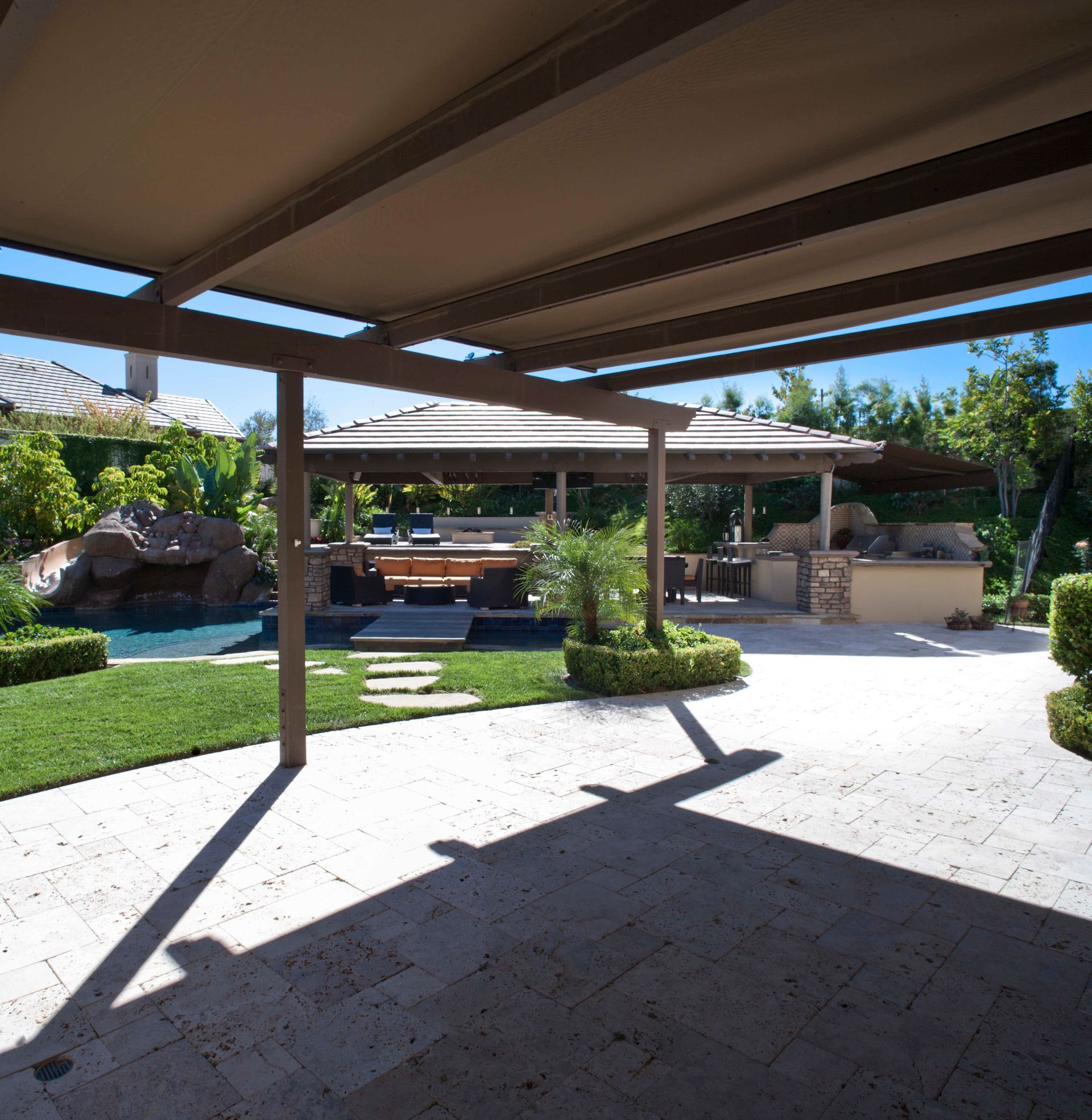 A patio area with a gazebo and a pool