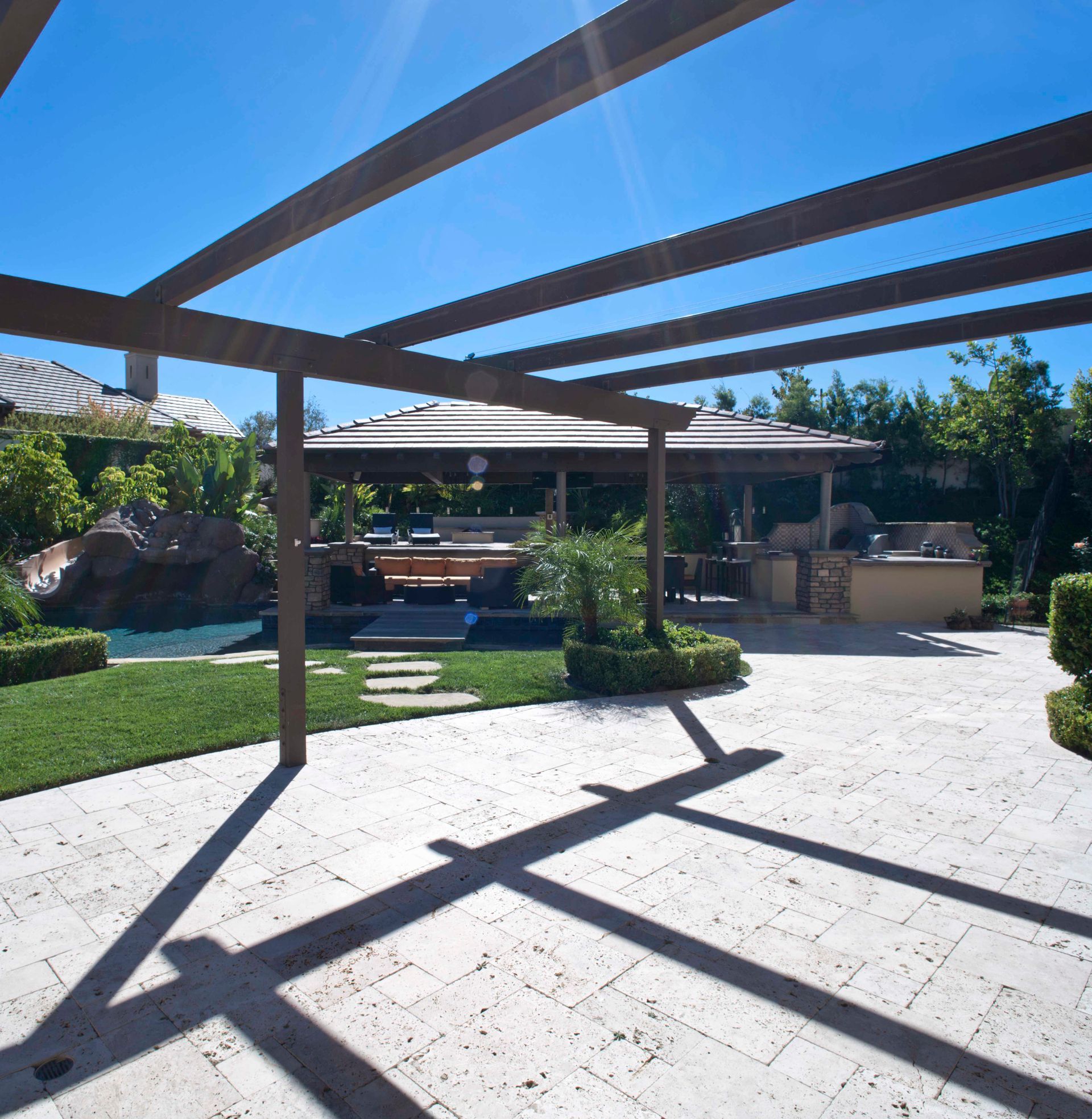 A patio area with a pergola and a swimming pool