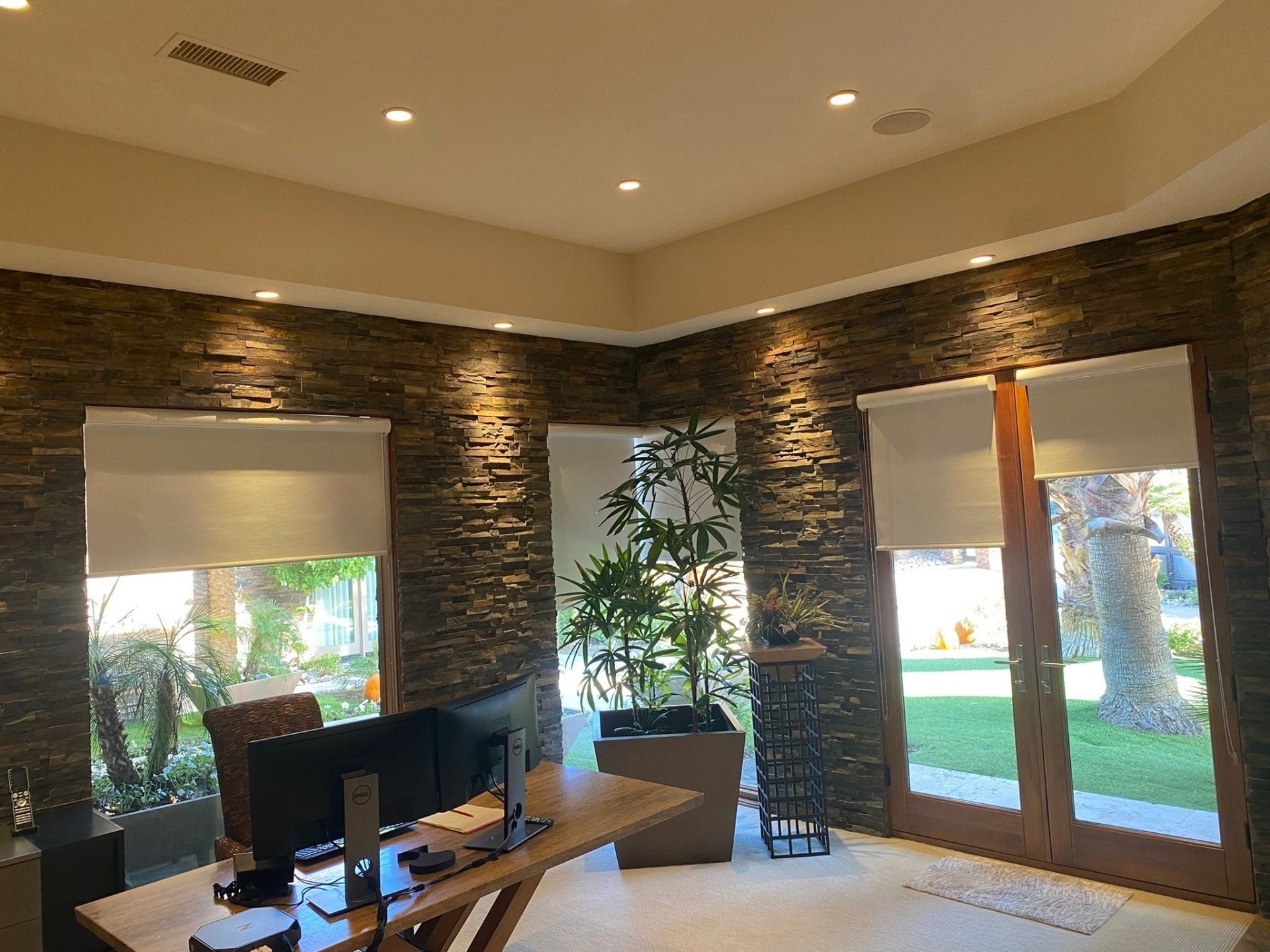 A room with a desk and a computer in it.